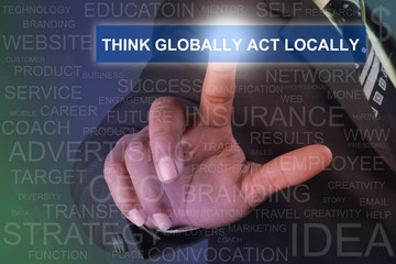 Fototapeta na wymiar Businessman touching think globally act locally button on virtual screen