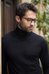 Thoughtful guy in black and spectacles