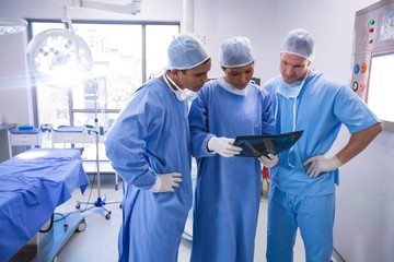 Fototapeta na wymiar Surgeons examining x-ray in operation room