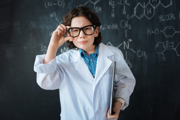 Charismatic little scientist enjoying class in the laboratory