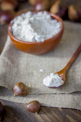 Natural organic chestnut flour in brown ceramic bowl.