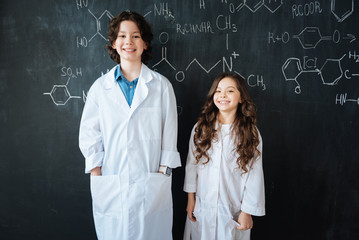 Charming pupils enjoying chemistry lesson in the laboratory