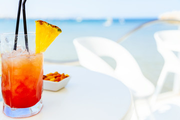 Fresh Red And Orange Cocktail Glass In Summer With Ocean Background