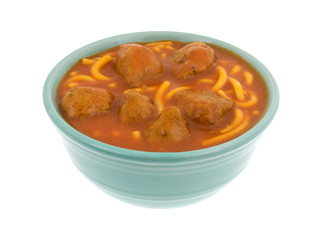 Bowl of spaghetti and meatballs isolated on a white background.