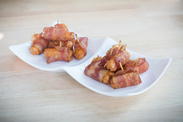 Deep fried sausages rolled in bacon