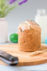 Easter cake standing on easter table, served by easter eggs milk and flowers.