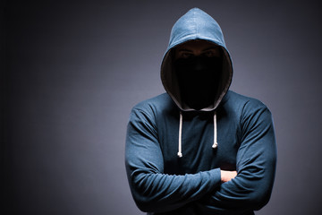Man wearing hood in dark room
