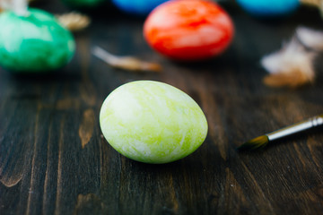 Yellow easter egg over brown rustic table.