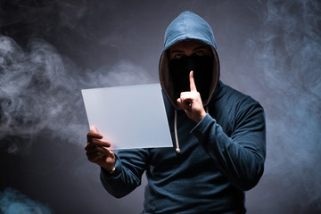 Naklejka premium Hacker working on tablet in dark