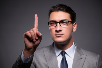 Handsome businessman pressing virtual buttons