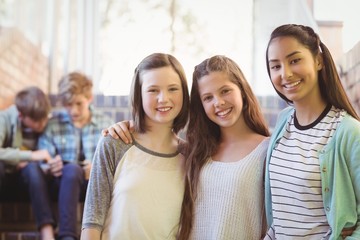 Portrait of smiling schoolgirls sitting on the staircase