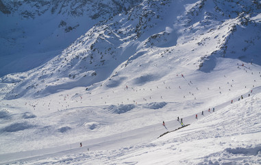 view of ski resort in mountains. Ski slopes. Rest in mountains in the winter. Skiing and snowboards.