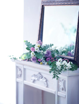 Beautiful composition with fresh flowers on mantelpiece