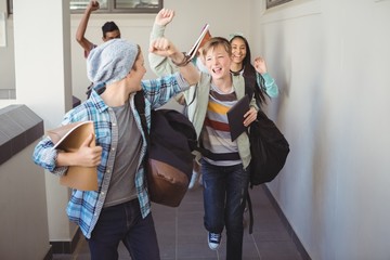 Group of classmate running in corridor 