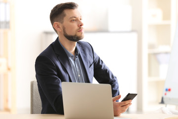 Handsome manager working in office © Africa Studio