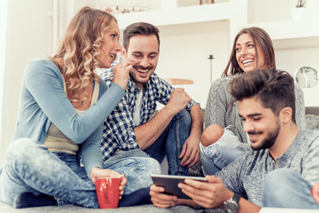 Cheerful group of friends having fun at home