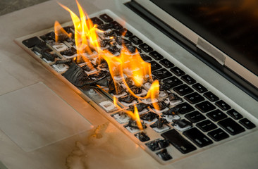 Laptop computer keyboard on fire and melting