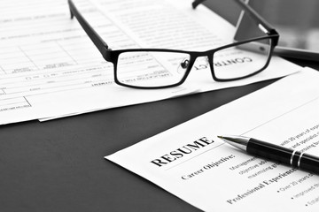 Closeup of resume with pen and glasses on the table 