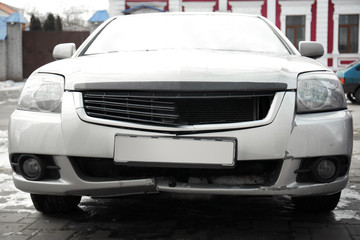 Broken bumper of car involved in accident, closeup