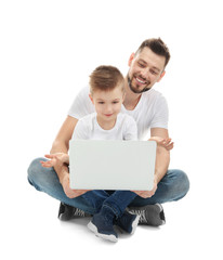 Handsome man and his son with laptop on white background
