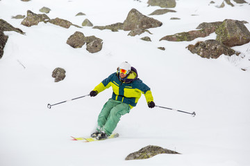 skier skiing on fresh snow on ski slope on Sunny winter day in the ski resort in Georgia