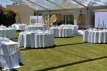 Special event decorated area and white furniture on the green grass sunny outside background
