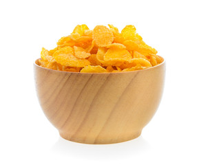 corn flakes in wood bowl isolated on white background