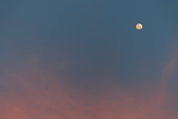 Pink cloud on sky with moon