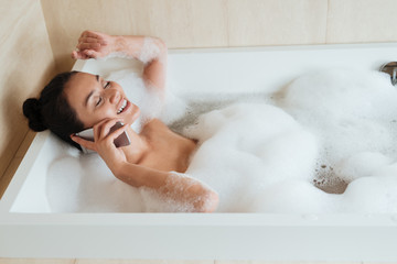 Portrait of a happy asian woman talking on mobile phone