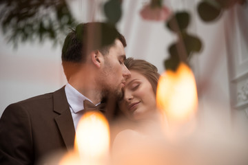 bride and groom with candles and leaves