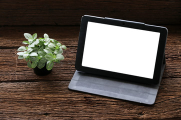 tablet on old wood table.Copy space