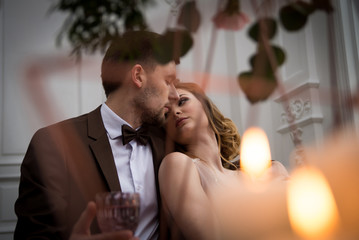 bride and groom with candles and leaves