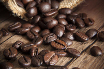 Roast coffee seed on wood table, macro image