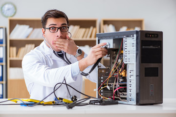 Fototapeta na wymiar IT technician repairing broken pc desktop computer