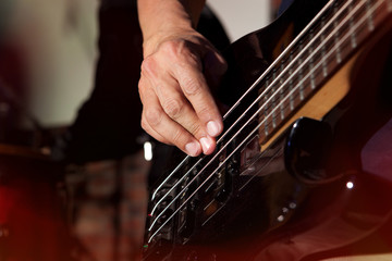 Fototapeta premium Bass guitar in hands of musician