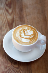 latte art coffee on wood background
