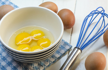 Raw eggs and whisk