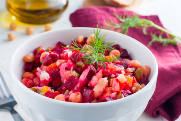 Vinaigrette with turkey peas (chickpeas) in a white bowl, selective focus