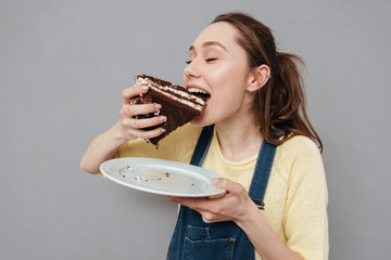 Hungry young pregnant woman going to eat chocolate cake