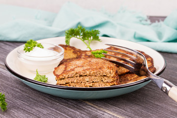 Liver Patties with Sour Cream and Parsley. Liver Cakes or Fritters of Liver. Healthy snack or take-away lunch bites.