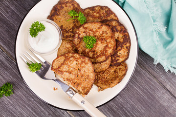 Liver Patties with Sour Cream and Parsley. Liver Cakes or Fritters of Liver. Healthy snack or take-away lunch bites. View from above, top studio shot