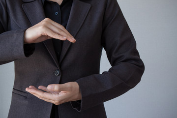 Business man with empty hand presenting something on grey background
