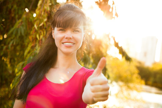 Successful woman showing thumbs up or Like