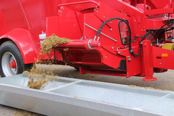 Agricultural Trailer Dispensing Animal Feed By Conveyor.