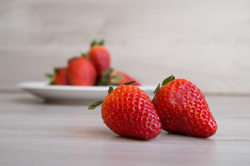 Strawberry couple on a wooden background