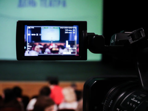 Shooting concert video. Control monitor. Blurred background, bokeh. Videography.