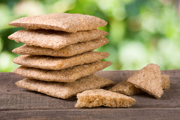 stack of crisp bread on a wooden table isolated white background
