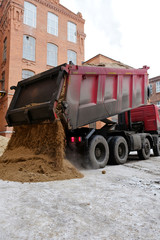 the truck pours the sand