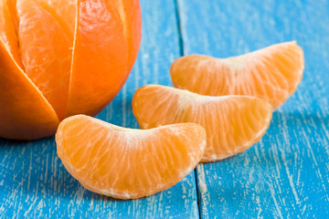 tangerine slices on a blue wooden background