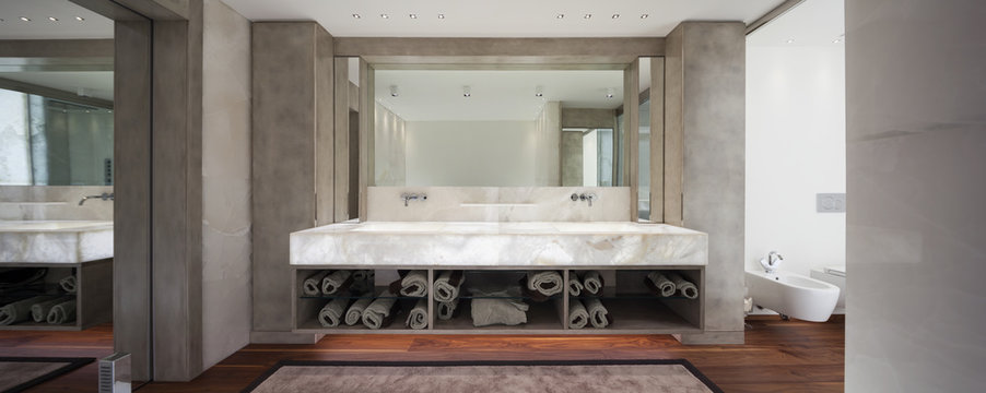 Modern bathroom with marble and parquet, nobody